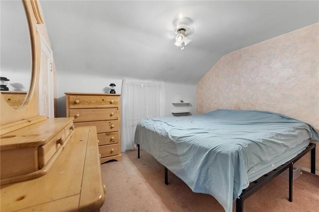 carpeted bedroom featuring vaulted ceiling