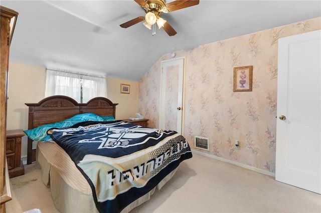 carpeted bedroom featuring ceiling fan and lofted ceiling