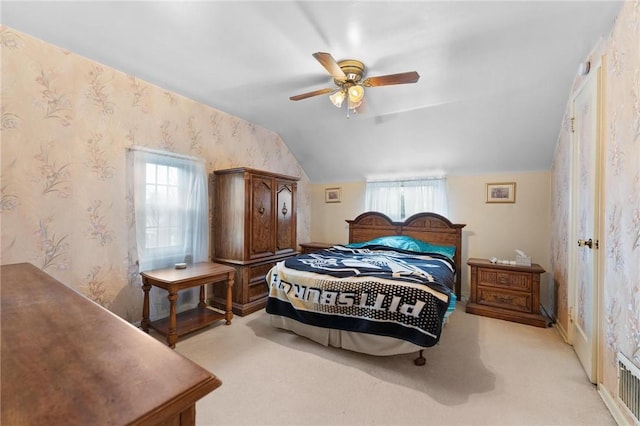 carpeted bedroom featuring ceiling fan and vaulted ceiling