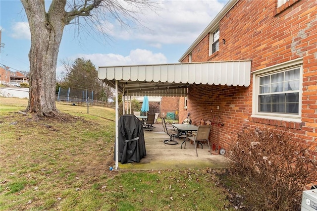 view of yard featuring a patio and a trampoline