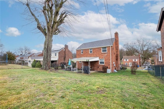 back of house with a yard