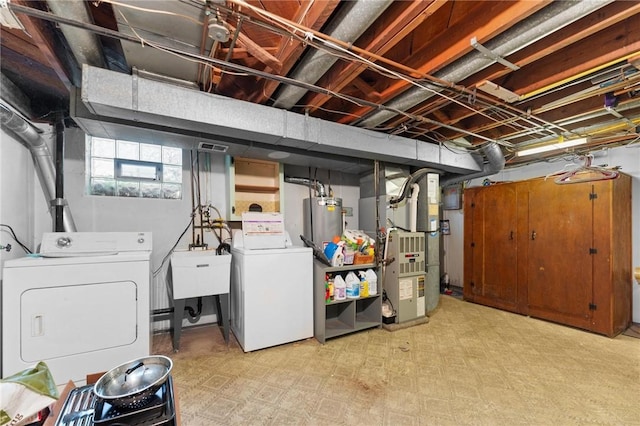 basement featuring washer and clothes dryer, heating unit, and water heater