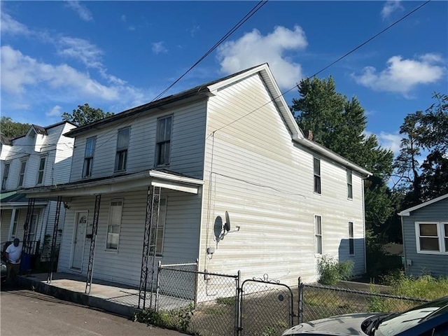 view of side of property with covered porch