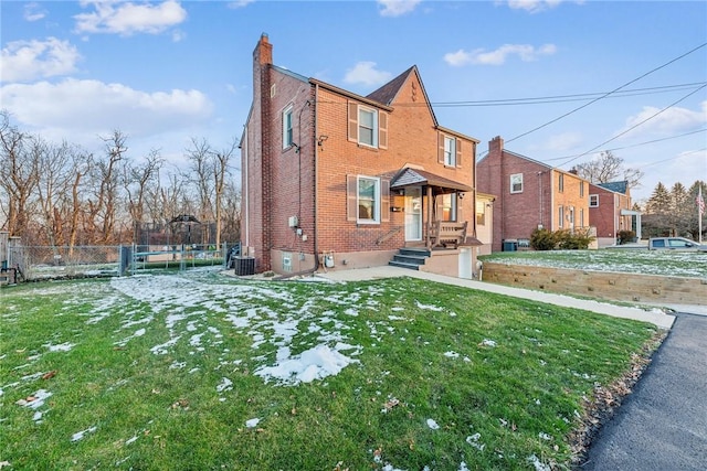 view of front of property featuring a front lawn and central air condition unit