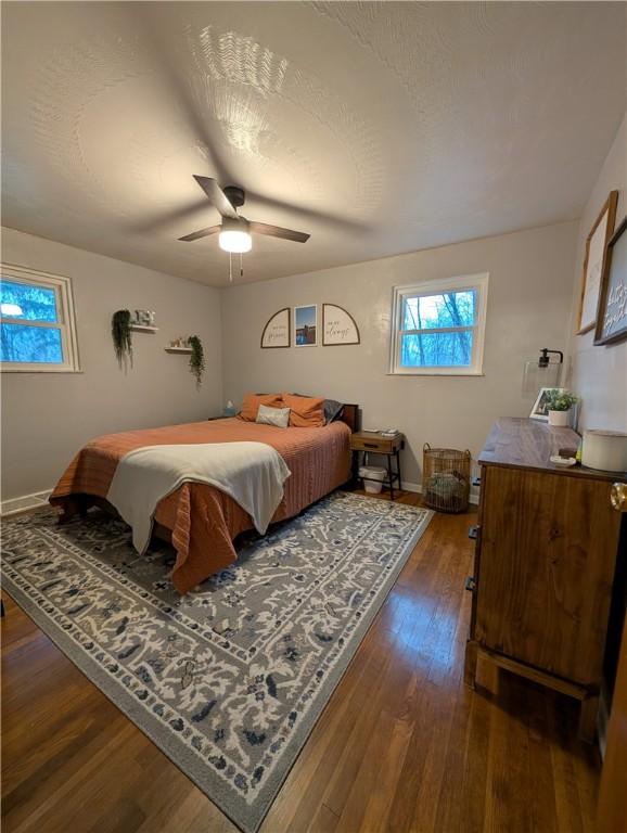 bedroom with ceiling fan and dark hardwood / wood-style flooring