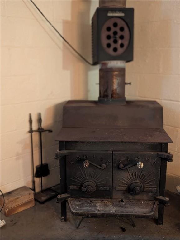 interior details featuring a wood stove and concrete floors