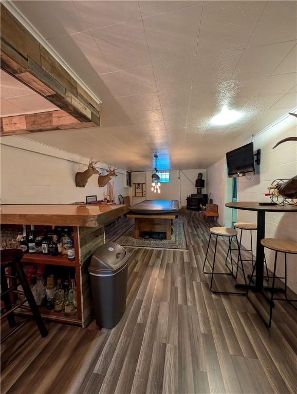 bar featuring dark hardwood / wood-style flooring and billiards