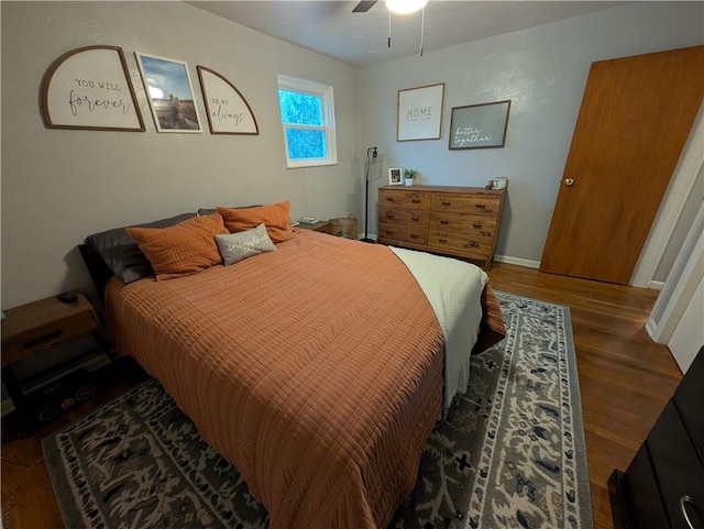 bedroom with ceiling fan and dark hardwood / wood-style floors