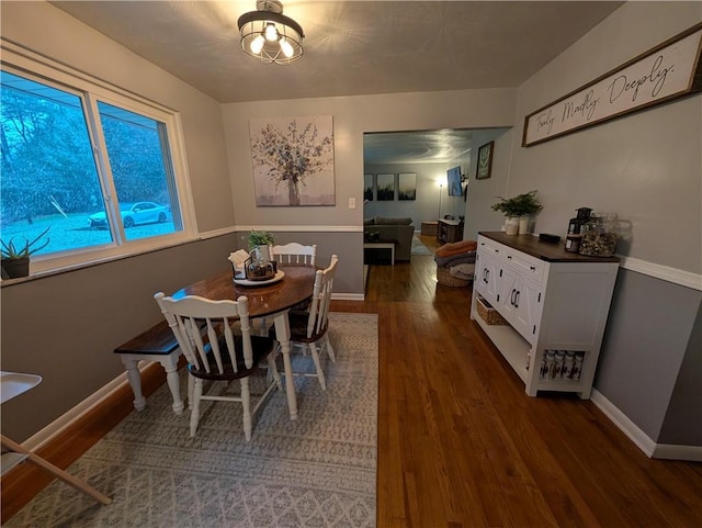 dining space with dark hardwood / wood-style flooring