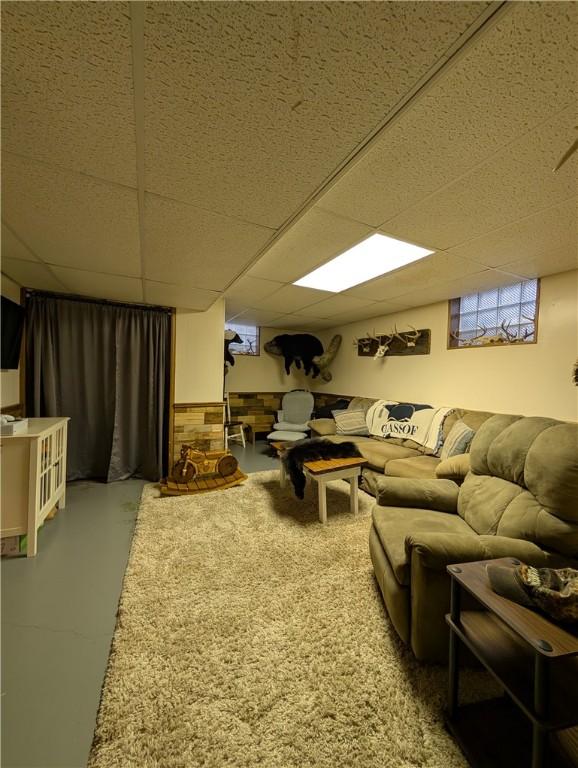 living room with a paneled ceiling