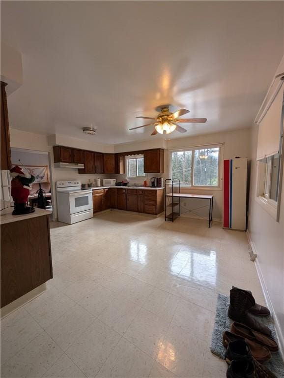 kitchen with white electric range oven and ceiling fan