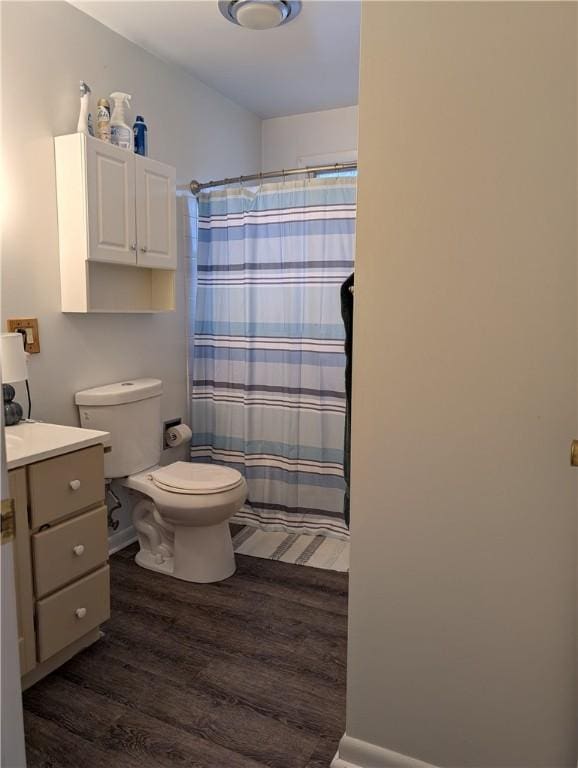 bathroom featuring hardwood / wood-style floors, vanity, toilet, and walk in shower