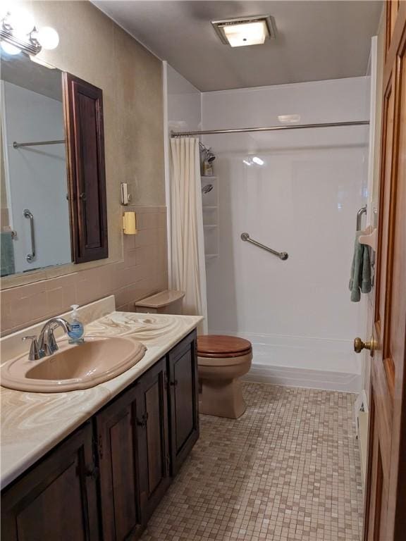 bathroom with tile patterned floors, vanity, and toilet