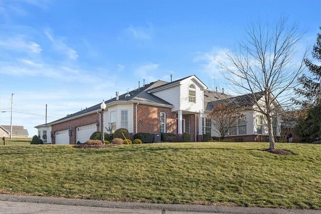 view of front of property featuring a garage and a front lawn