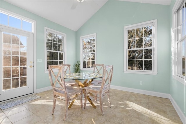 tiled dining area featuring ceiling fan and lofted ceiling