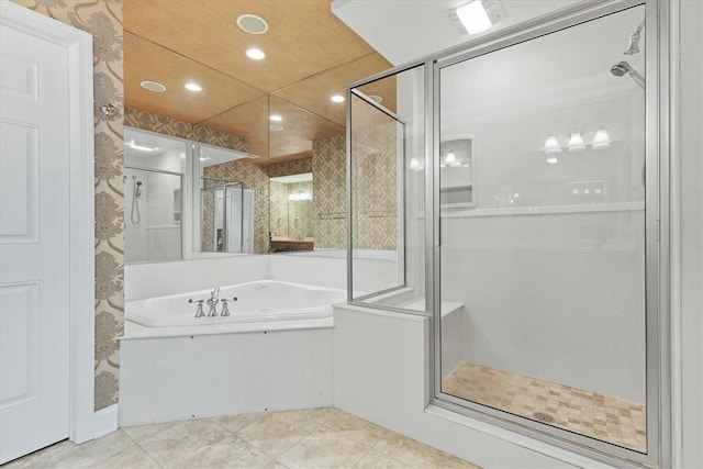 bathroom featuring tile patterned flooring and shower with separate bathtub