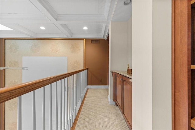 hall with light carpet, crown molding, beamed ceiling, and coffered ceiling