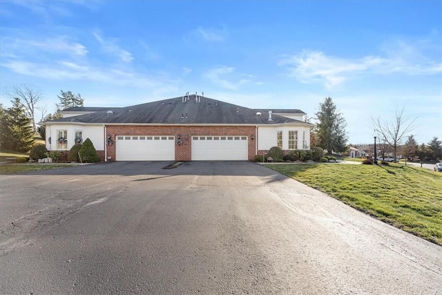 single story home with a garage and a front lawn