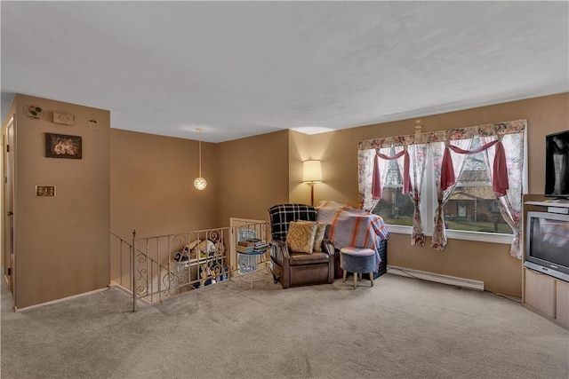 sitting room with carpet floors and a baseboard heating unit