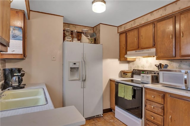 kitchen with decorative backsplash, sink, light parquet floors, and white appliances