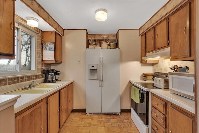 kitchen featuring decorative backsplash, white appliances, sink, and light parquet floors