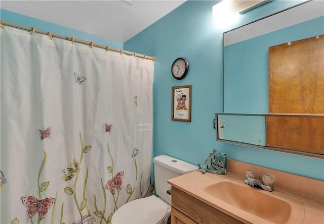 bathroom with vanity, toilet, and walk in shower