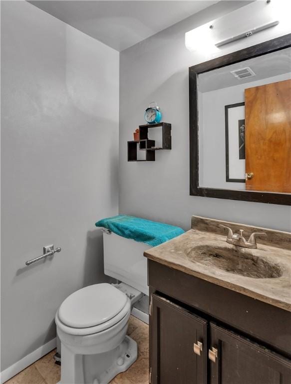 bathroom featuring tile patterned floors, vanity, and toilet