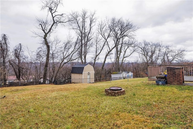 view of yard featuring a fire pit and an outbuilding