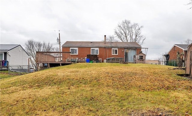 rear view of property with a yard and a deck