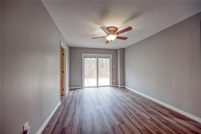 unfurnished room with ceiling fan and dark hardwood / wood-style flooring