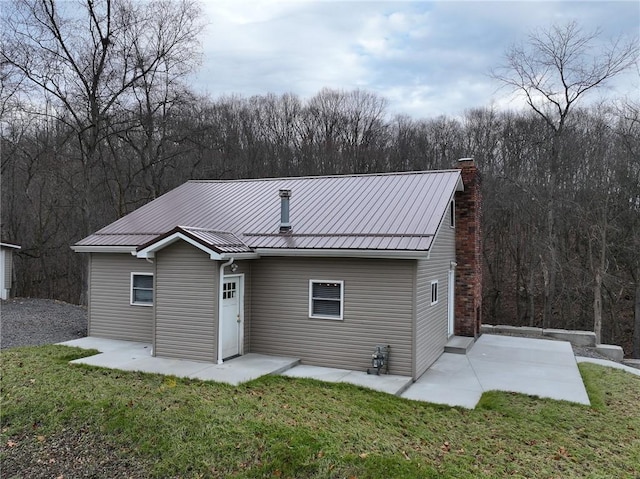 back of property featuring a yard and a patio