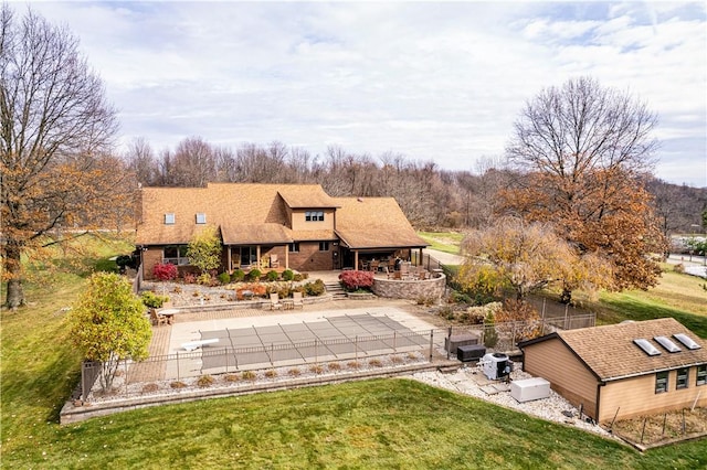 back of property with a lawn and a patio area