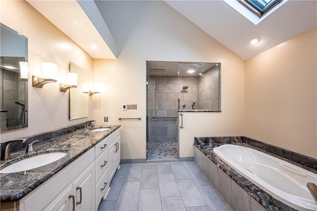 bathroom with vaulted ceiling with skylight, vanity, independent shower and bath, and tile patterned flooring