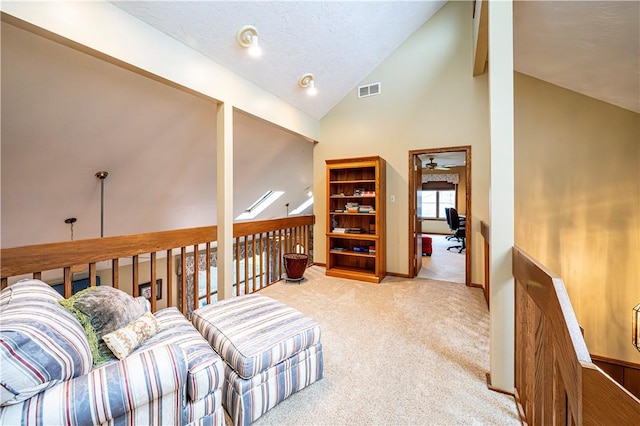 sitting room with a textured ceiling, carpet floors, high vaulted ceiling, and ceiling fan