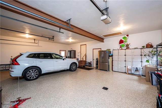 garage featuring a garage door opener and stainless steel refrigerator