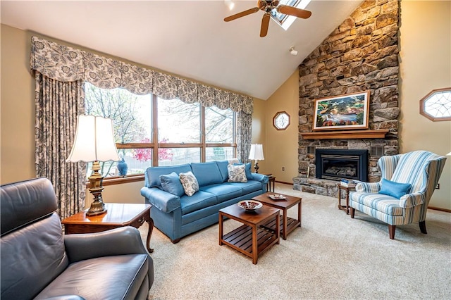 carpeted living room featuring ceiling fan, a healthy amount of sunlight, a stone fireplace, and high vaulted ceiling