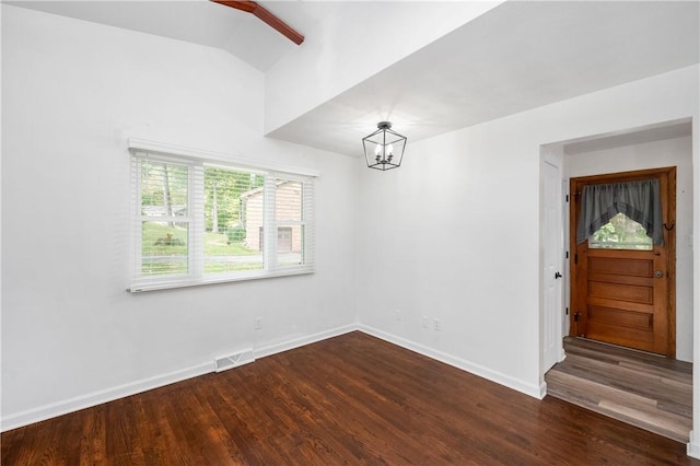 unfurnished dining area with an inviting chandelier, hardwood / wood-style flooring, and vaulted ceiling