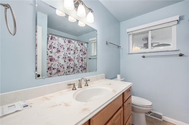 bathroom featuring tile patterned floors, vanity, and toilet