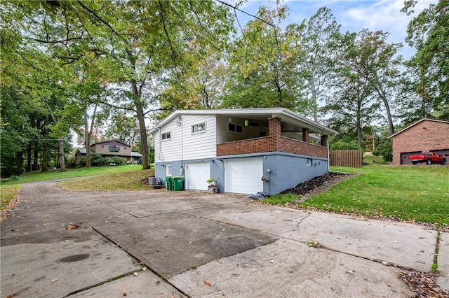 view of side of home with a garage and a lawn