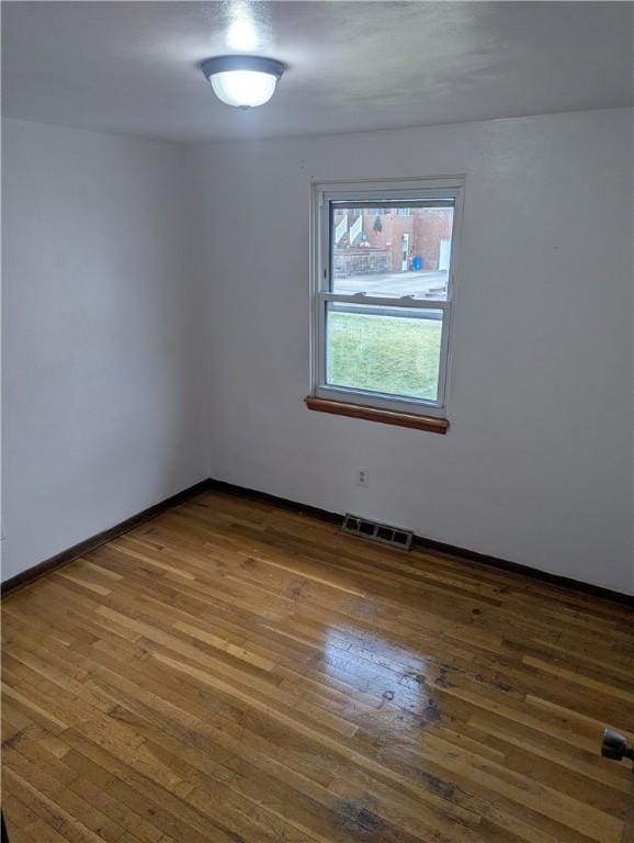 spare room with dark hardwood / wood-style floors