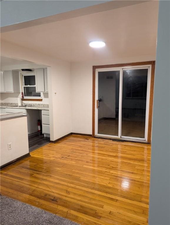 kitchen featuring white cabinets and light hardwood / wood-style floors