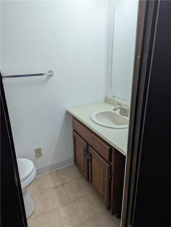 bathroom with tile patterned flooring, vanity, and toilet