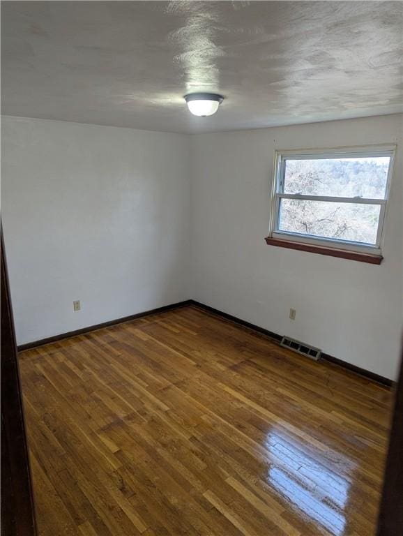 spare room featuring dark hardwood / wood-style floors