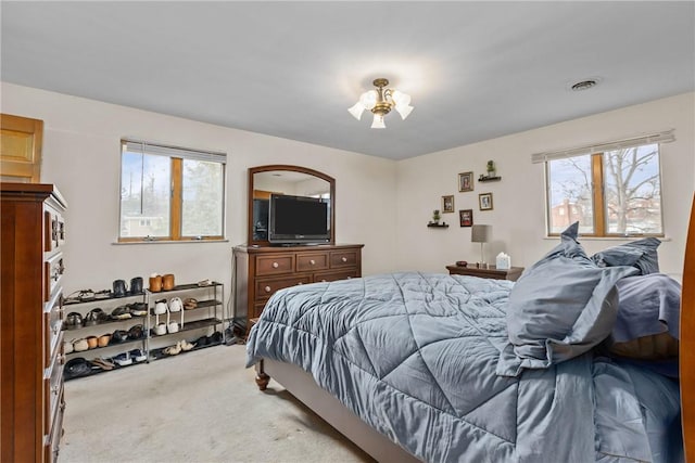 bedroom featuring light colored carpet