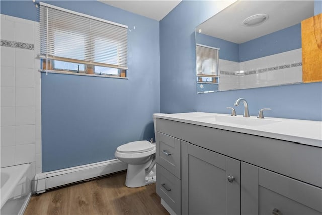 full bathroom with baseboard heating, wood-type flooring, toilet, shower / washtub combination, and vanity