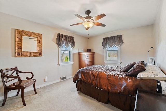 bedroom featuring ceiling fan and light carpet