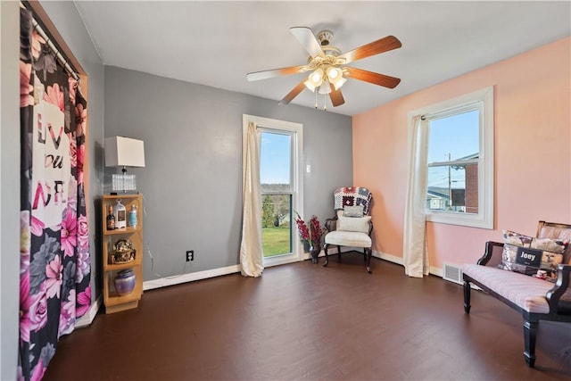 sitting room featuring ceiling fan and dark hardwood / wood-style floors