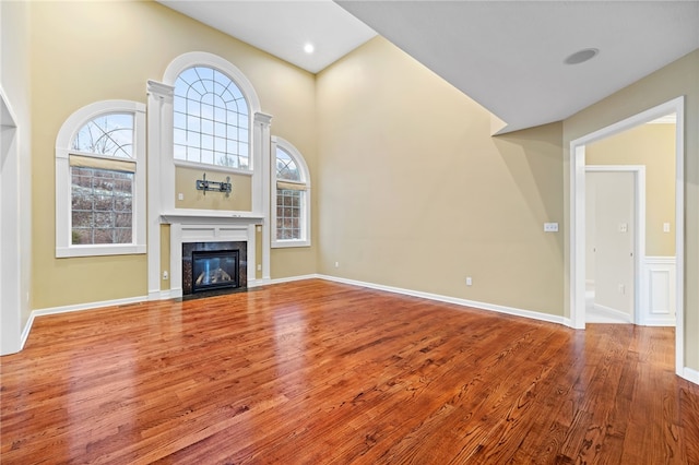 unfurnished living room featuring a fireplace and hardwood / wood-style floors