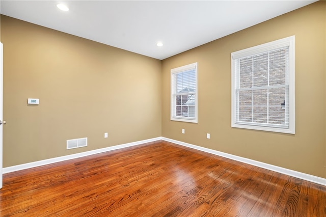 unfurnished room featuring hardwood / wood-style floors