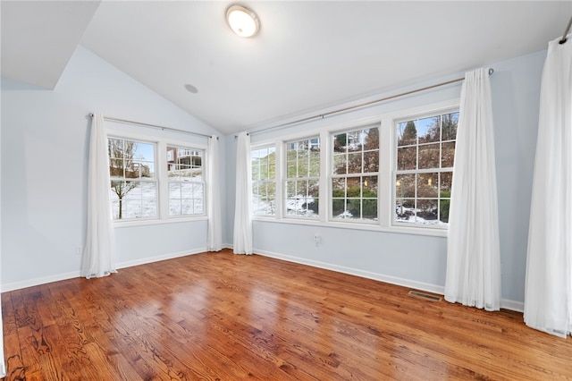 unfurnished sunroom with lofted ceiling